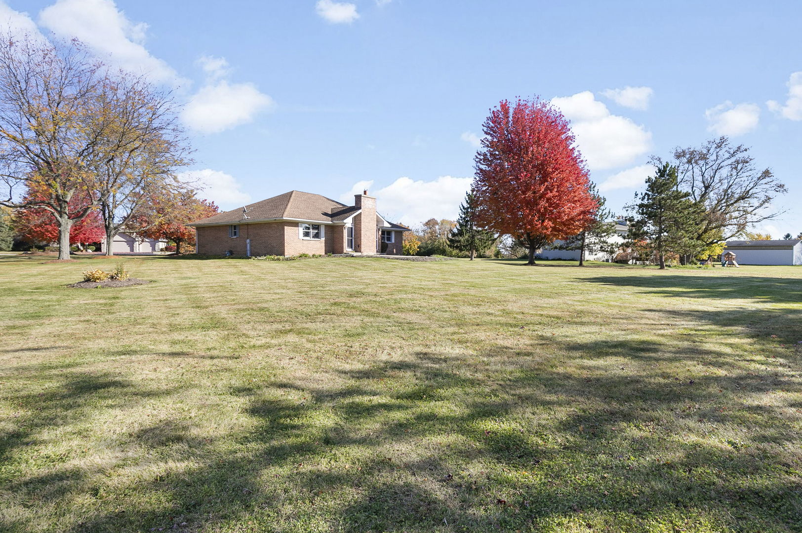 10201 Fox Bluff Lane Spring Grove, IL 60081 - Photo 25 of 26 a front view of a house with a yard and trees