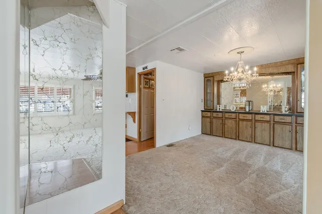 a bathroom with a tub sink shower and mirror