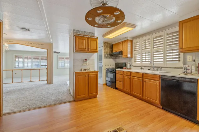 a open kitchen with a sink cabinets and window
