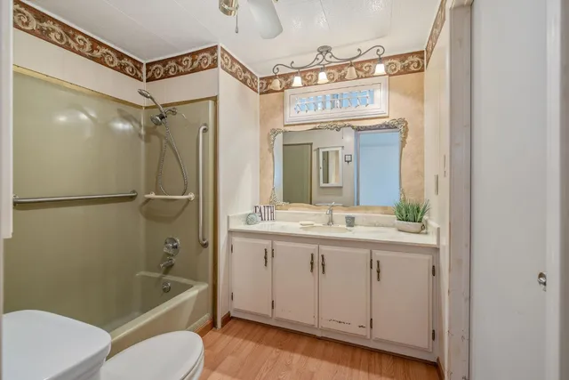 a bathroom with a tub a sink and mirror