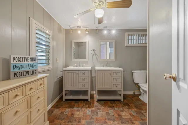 a bathroom with a sink a vanity and a mirror