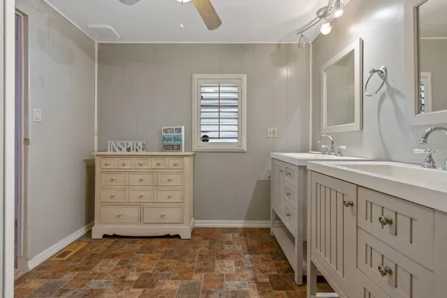 a bathroom with a sink a vanity and a mirror