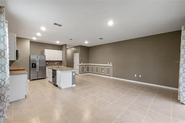 a view of kitchen with refrigerator and window