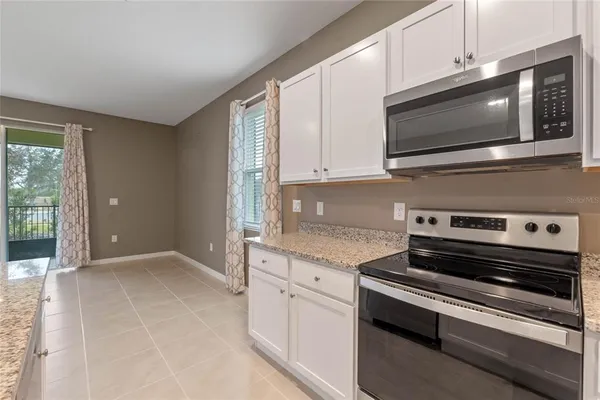 a kitchen with a sink and chandelier