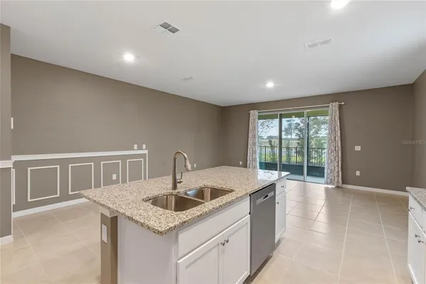 a kitchen with stainless steel appliances granite countertop a refrigerator a sink a stove with cabinets