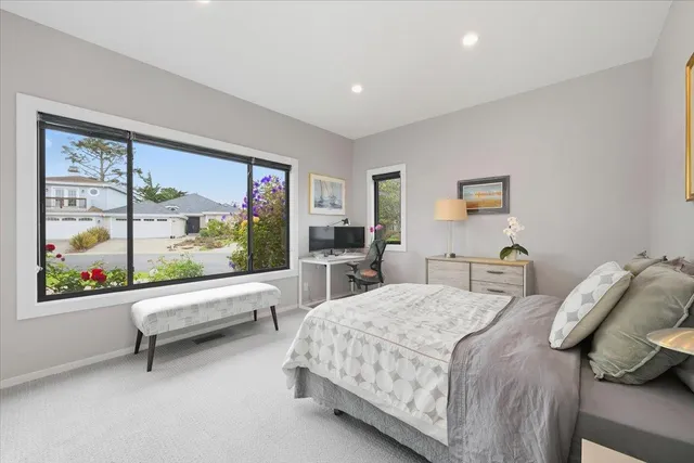 a bedroom with a large bed and a large window