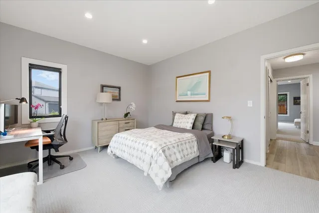 a bedroom with a bed and a desk