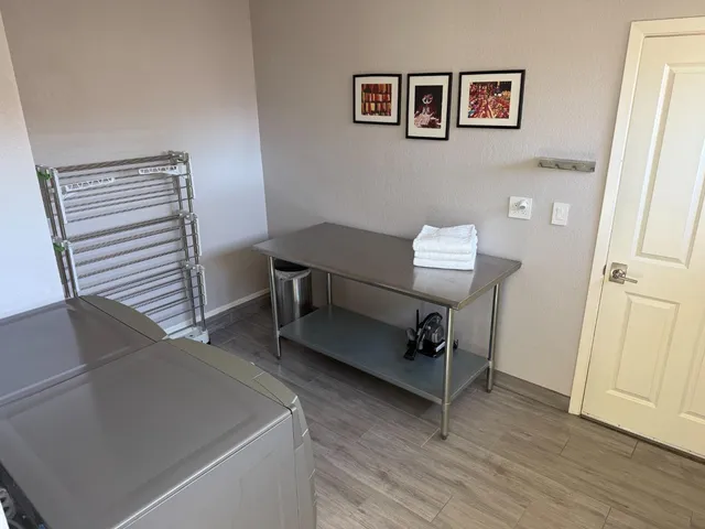 a room with a table chairs and wooden floor