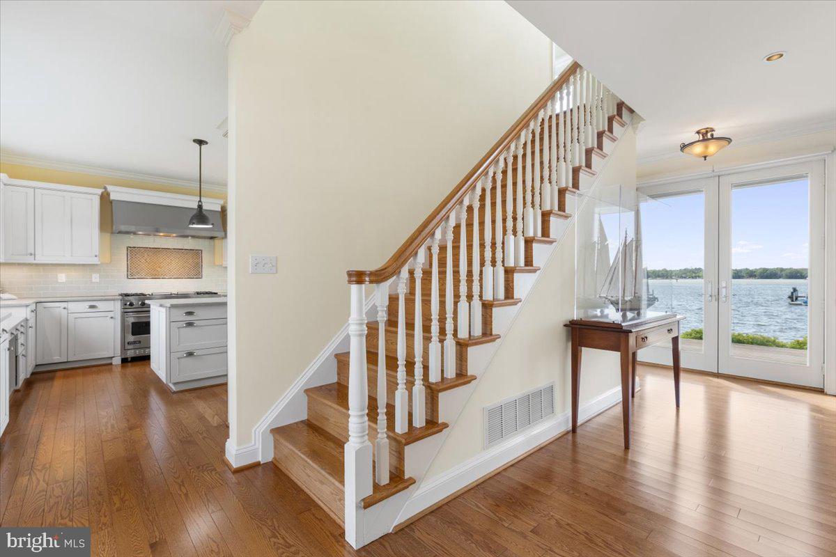 1100 Steamboat Road Shady Side, MD 20764 - Photo 12 of 81 a view of staircase with wooden floor and a large window