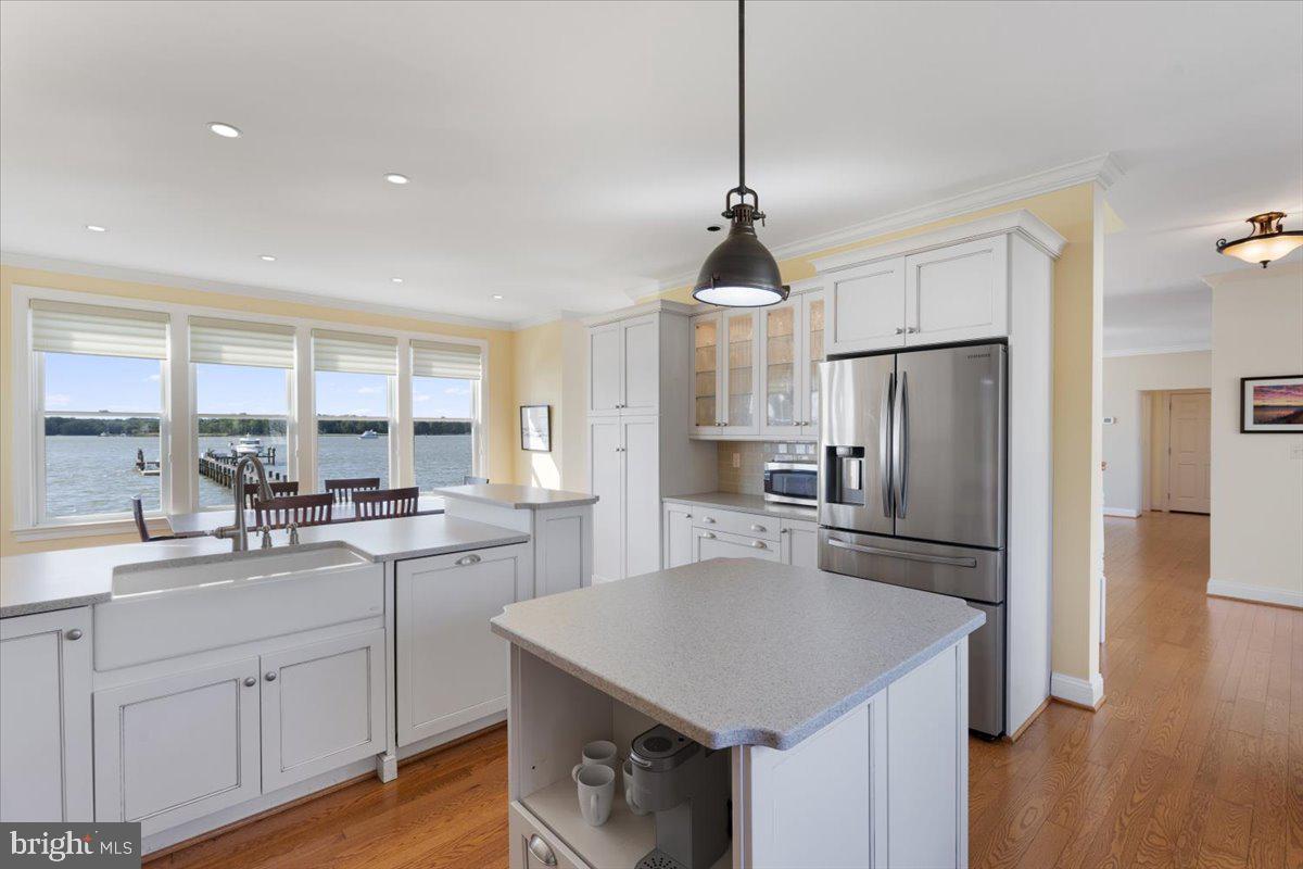 1100 Steamboat Road Shady Side, MD 20764 - Photo 15 of 81 a kitchen with a sink a center island and stainless steel appliances