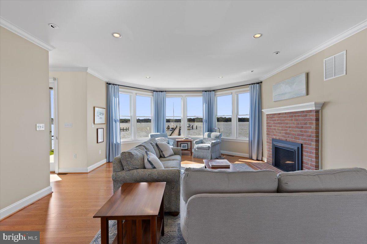 1100 Steamboat Road Shady Side, MD 20764 - Photo 20 of 81 a living room with furniture and a fireplace