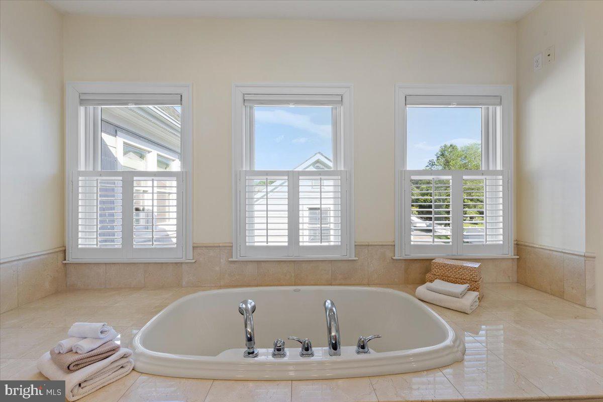 1100 Steamboat Road Shady Side, MD 20764 - Photo 36 of 81 a white bath tub sitting in a bathroom next to a window