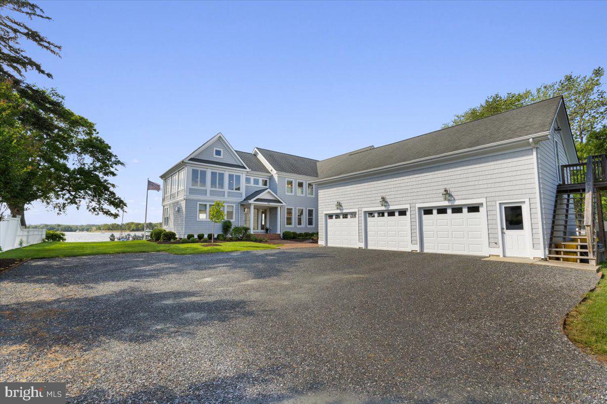 1100 Steamboat Road Shady Side, MD 20764 - Photo 8 of 81 a front view of a house with a yard and garage