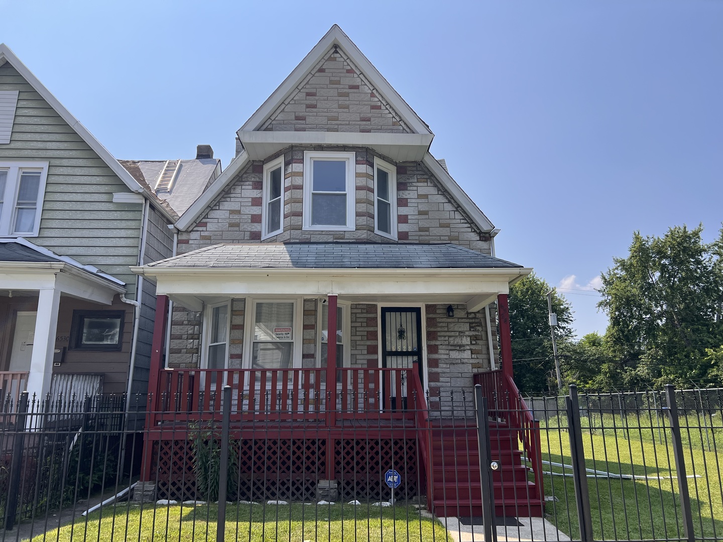 6528 South Sangamon Street Chicago, IL 60621 - Photo 1 of 14 a front view of a house with a yard