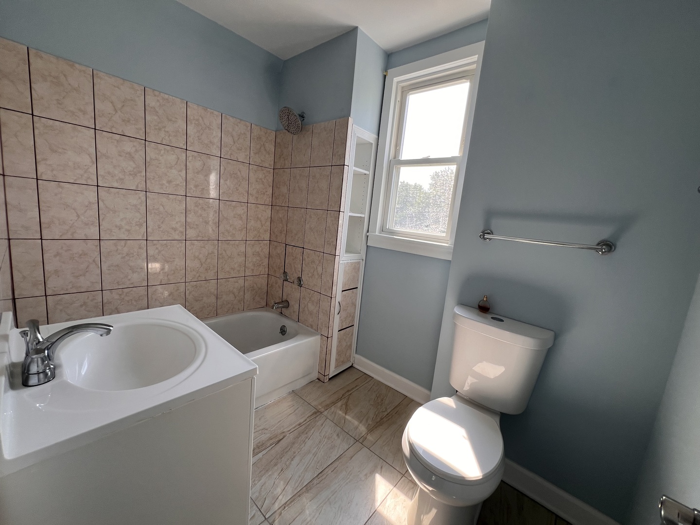 6528 South Sangamon Street Chicago, IL 60621 - Photo 9 of 14 a white toilet sitting next to a bathroom sink