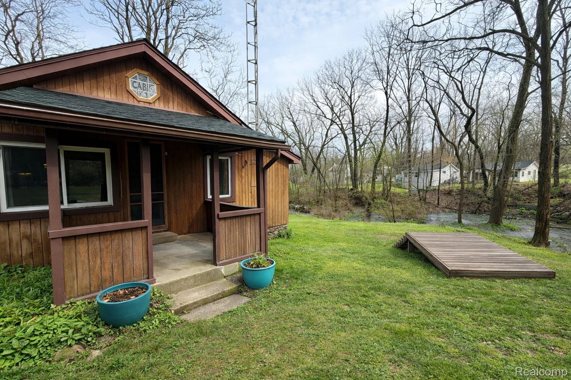 10044 Locust Drive Fenton, MI 48430 - Photo 2 of 20 View of grassy yard with a porch