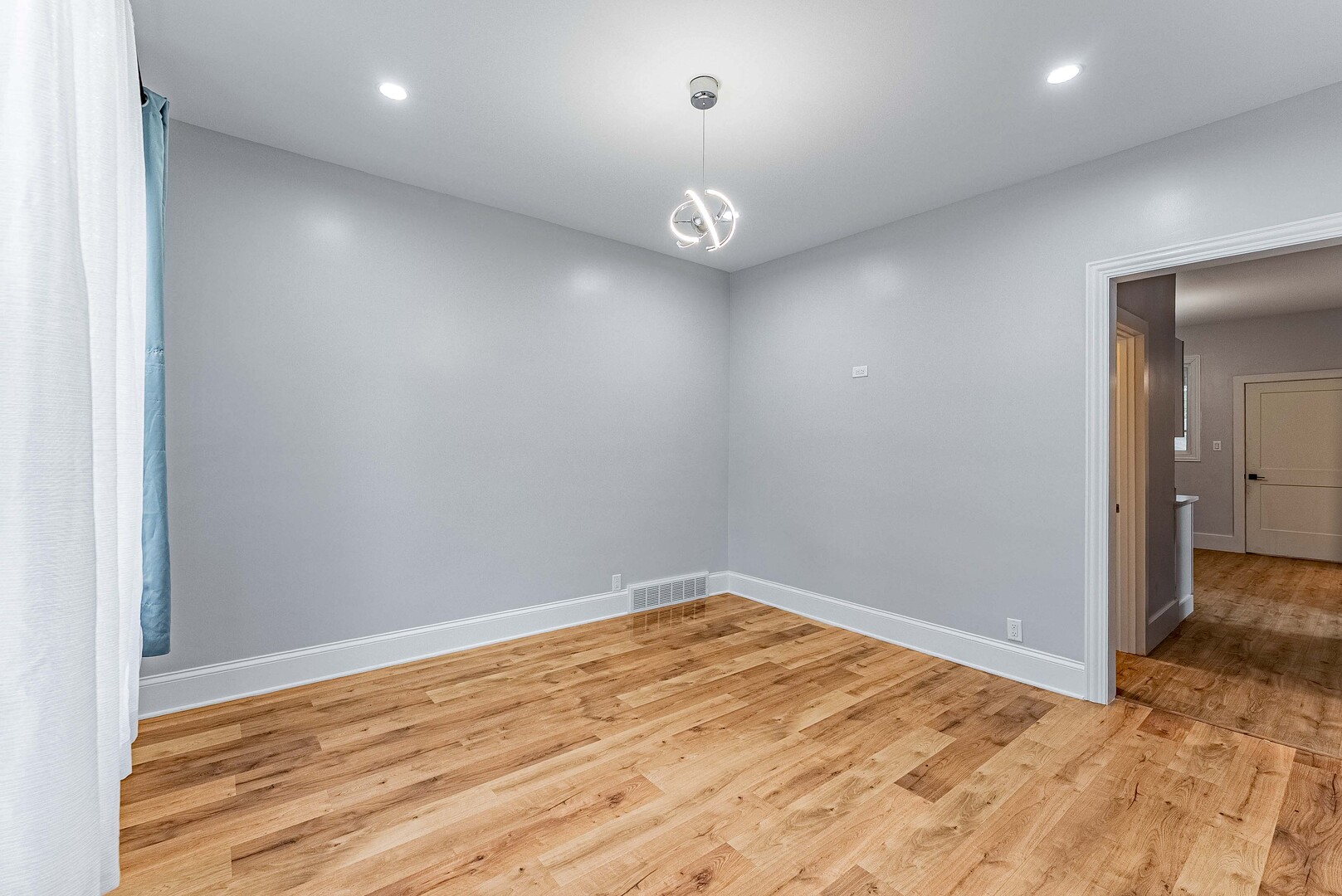 1330 Ridgeland Avenue Berwyn, IL 60402 - Photo 3 of 23 an empty room with wooden floor and fan
