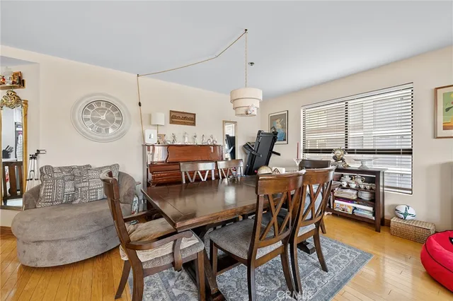 a dining room with furniture and wooden floor