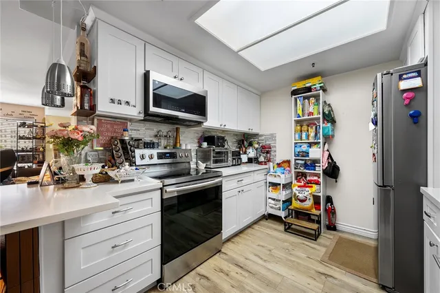 a kitchen with stainless steel appliances granite countertop a sink and cabinets