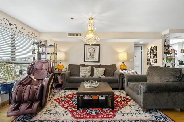 a living room with furniture a rug and a window