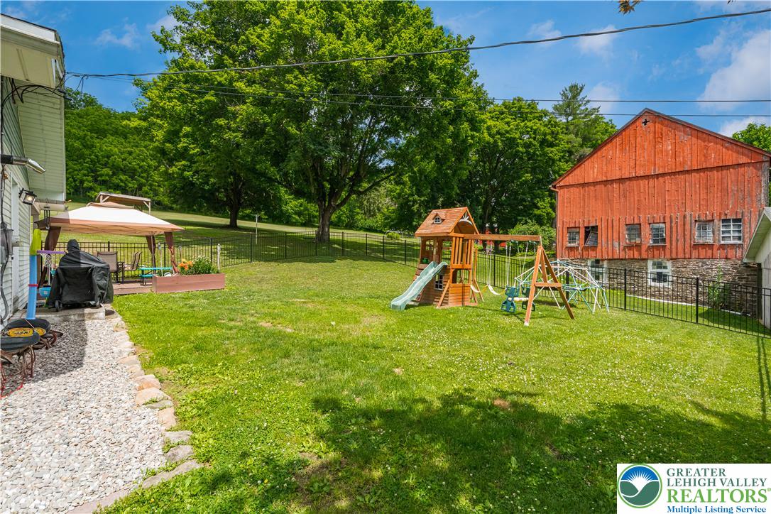50 Kohls Road Northampton, PA 18067 - Photo 42 of 54 A spacious, fenced backyard offers a dedicated play area, charming gazebo, and verdant surroundings.