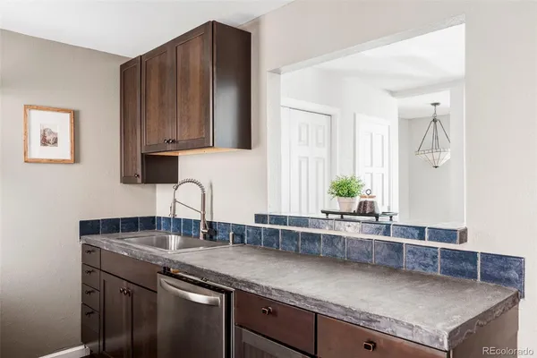 a kitchen with granite countertop a sink and a cabinets