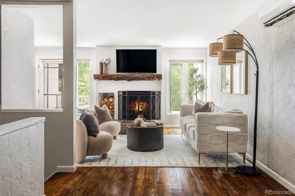 a living room with furniture a flat screen tv and a fireplace