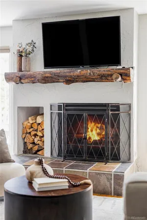 a living room with fireplace furniture and a flat screen tv