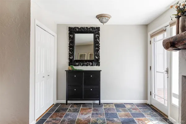 a view of a hallway with wooden floor and a bathroom