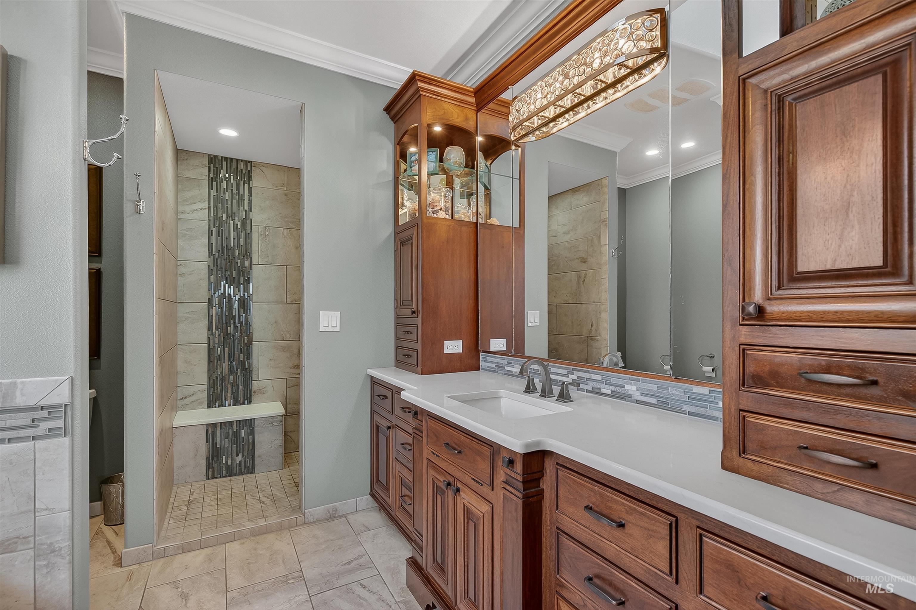 3978 Foothill Drive Lewiston, ID 83501 - Photo 23 of 40 Full bathroom with vanity, ornamental molding, tiled shower, recessed lighting, and tasteful backsplash