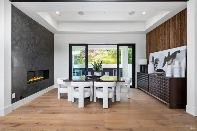 a view of a living room with kitchen view and wooden floor
