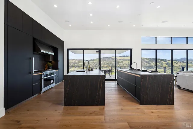 a living room with furniture large window and wooden floor