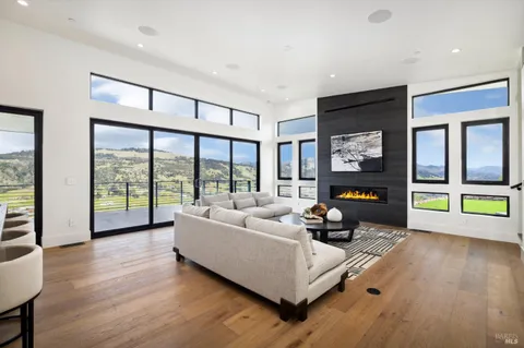 a living room with furniture and a floor to ceiling window