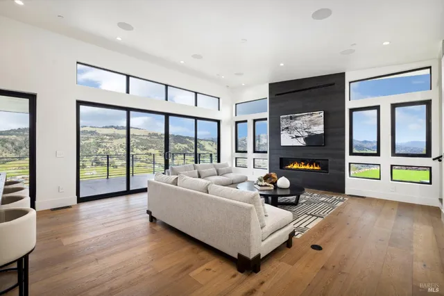 a living room with furniture and a floor to ceiling window