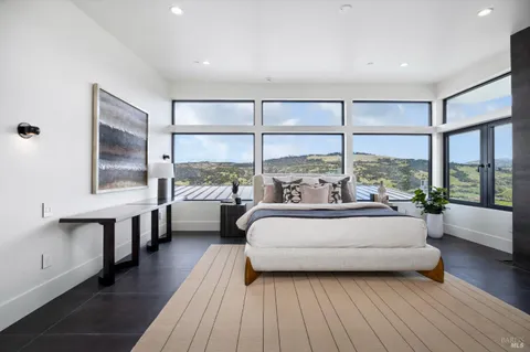 a spacious bathroom with a double vanity sink a mirror and a bathtub