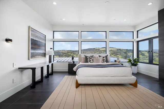 a spacious bathroom with a double vanity sink a mirror and a bathtub