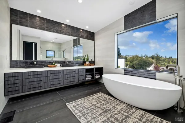 a bathroom with a sink and mirror with toilet