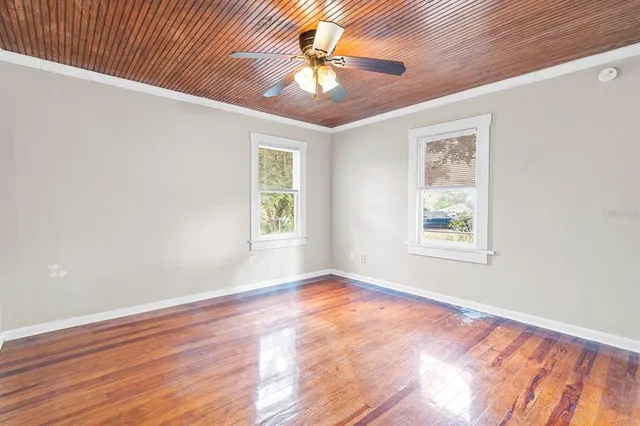 wooden floor in an empty room with a window