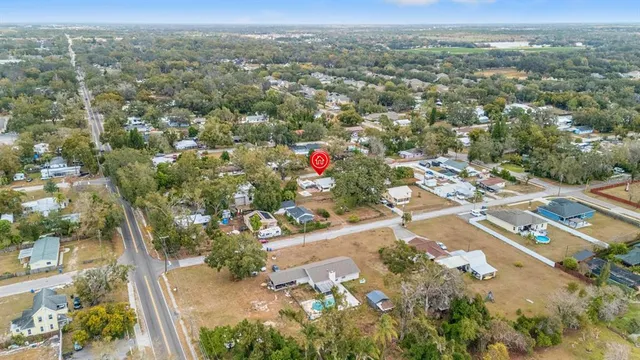 an aerial view of a house with a yard