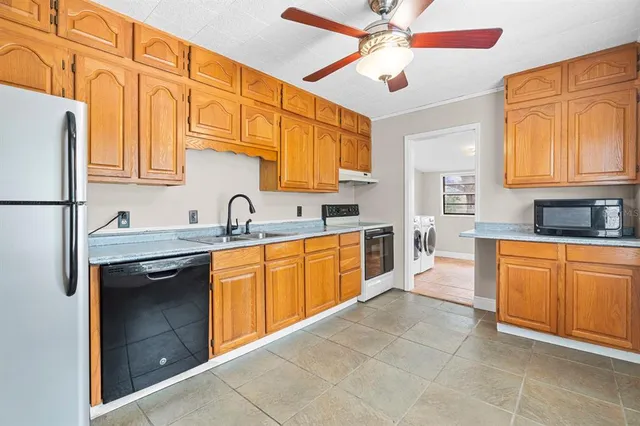 a kitchen with stainless steel appliances granite countertop a sink and cabinets