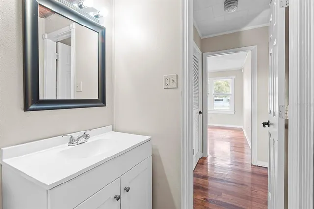 a bathroom with a sink a mirror and a vanity