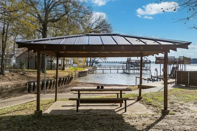 a view of patio with table and chairs under an umbrella