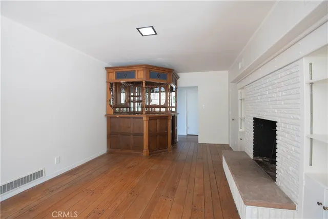 a view of a kitchen with furniture and wooden floor