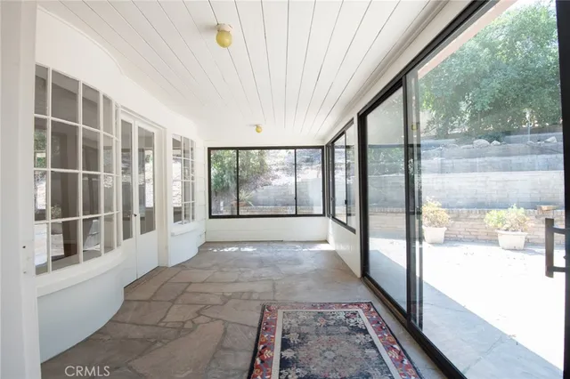 a view of a room with wooden floor