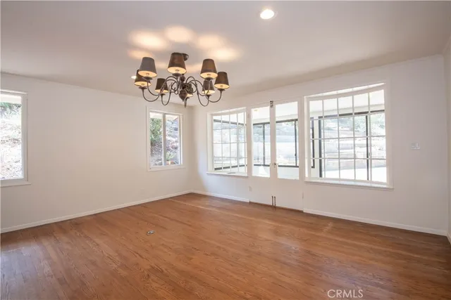 a bathroom with a granite countertop sink toilet and mirror
