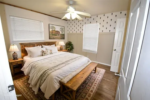 a bedroom with a bed and a chandelier