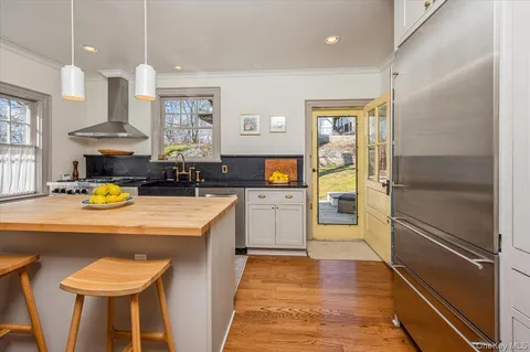 a kitchen with a refrigerator and a sink