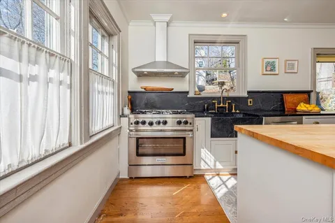 a kitchen with stainless steel appliances granite countertop a stove and a refrigerator