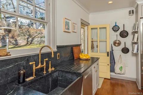 a kitchen with granite countertop a stove and a sink