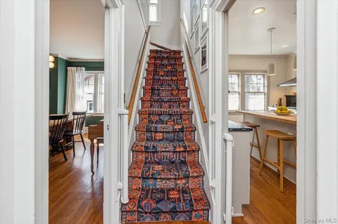 view of hall way with furniture and wooden floor